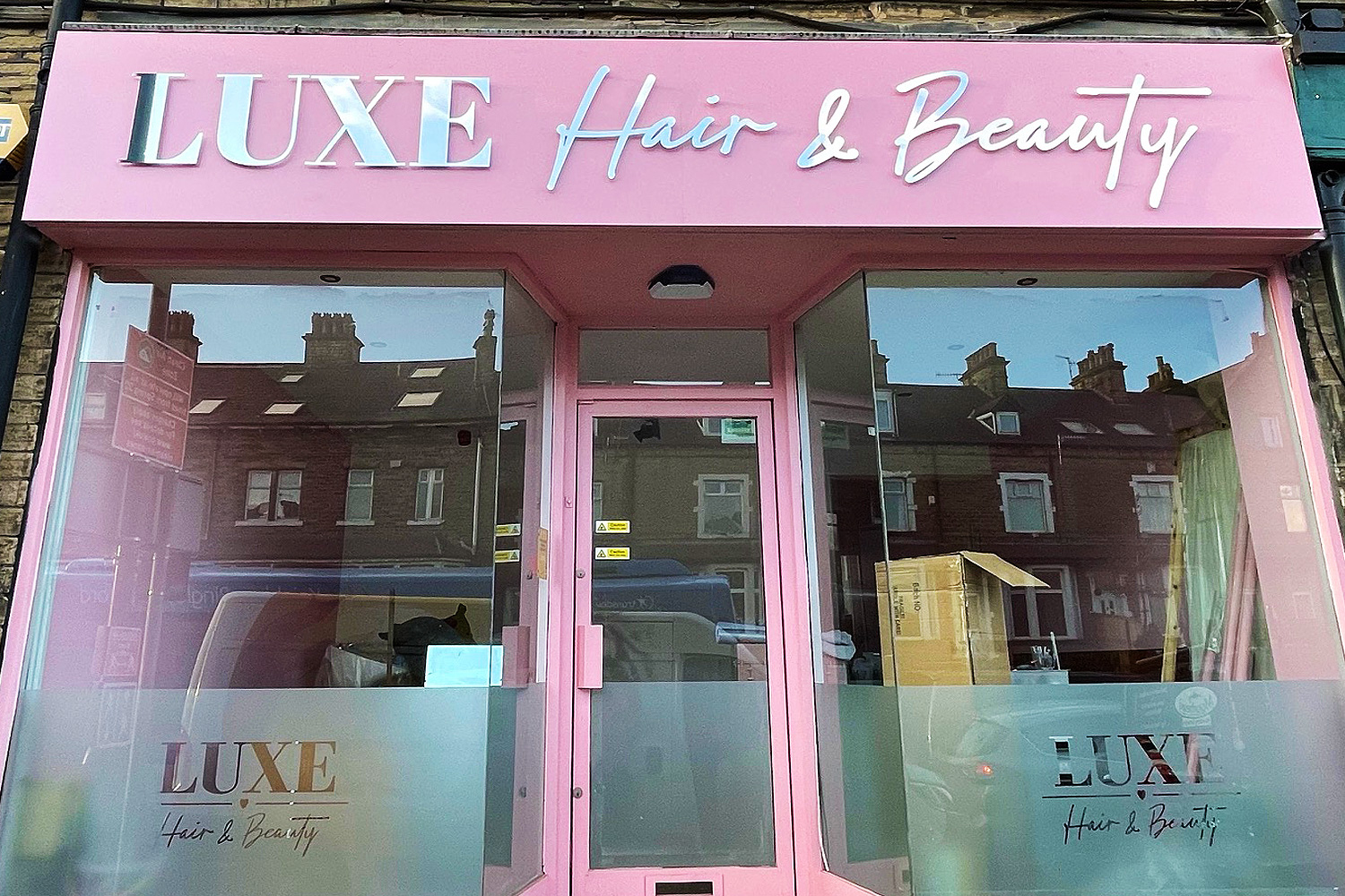 Luxe Hair & Beauty pink shopfront with reflective silver and white lettering and large display windows