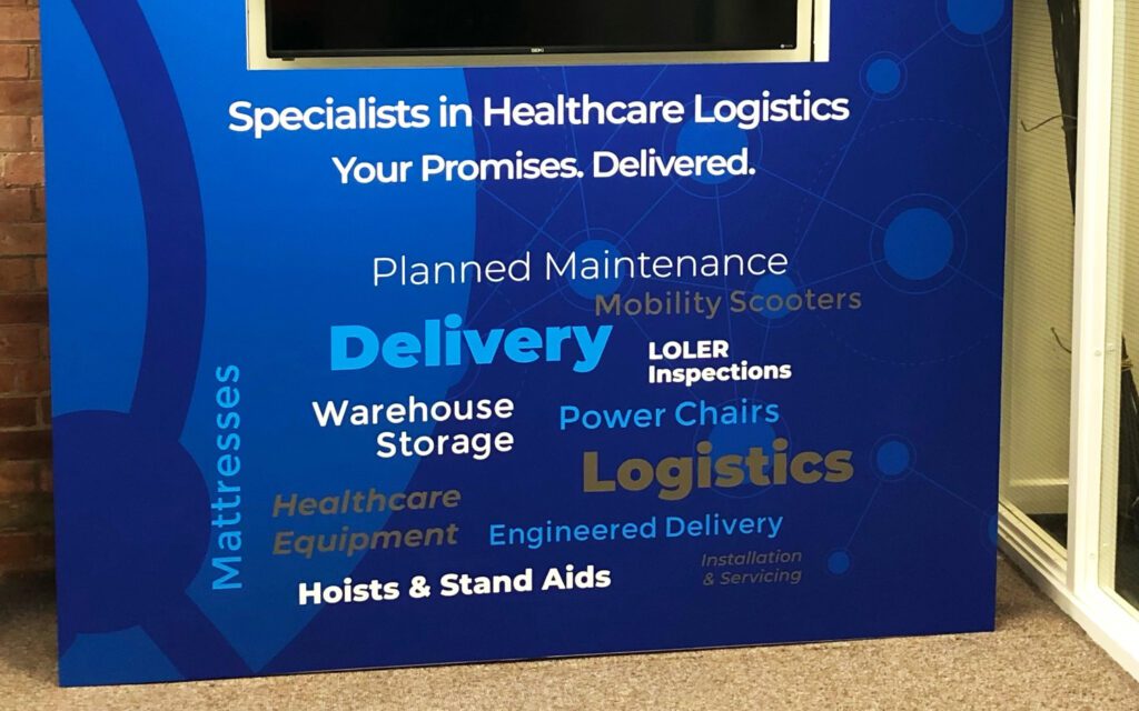 Promotional display stand with custom graphic wrap, designed for brand visibility at exhibitions or retail environments