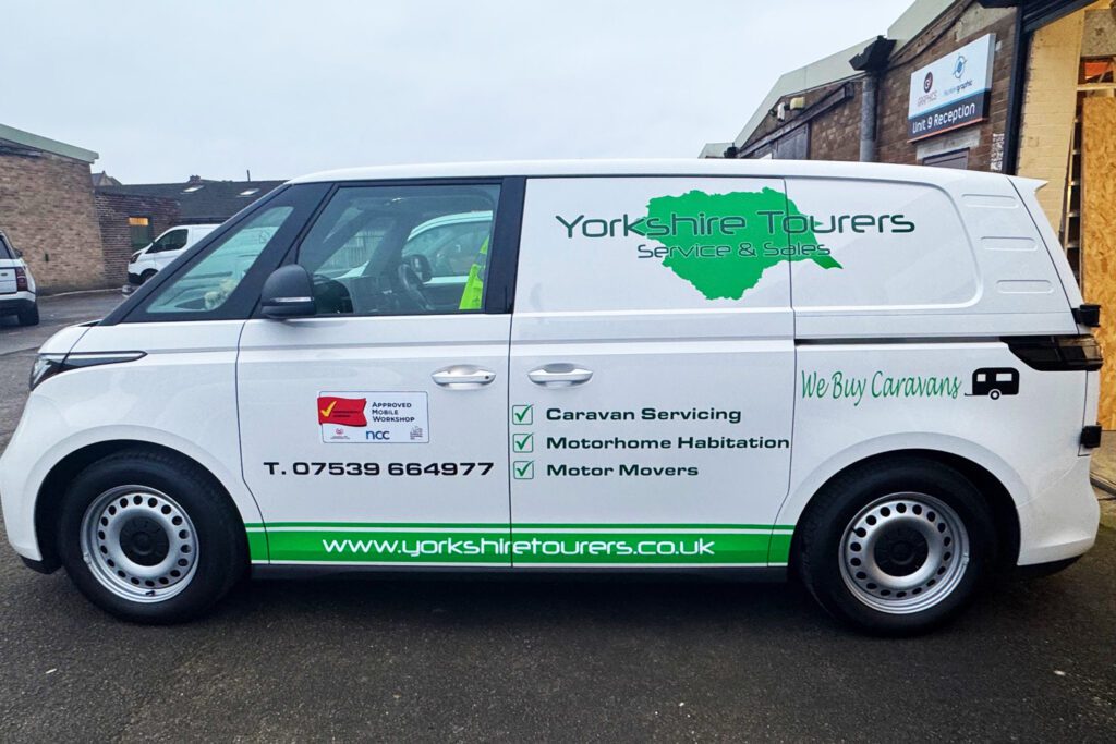 Yorkshire Tourers service and sales van with green map logo, service list, and contact details, offering caravan and motorhome repairs