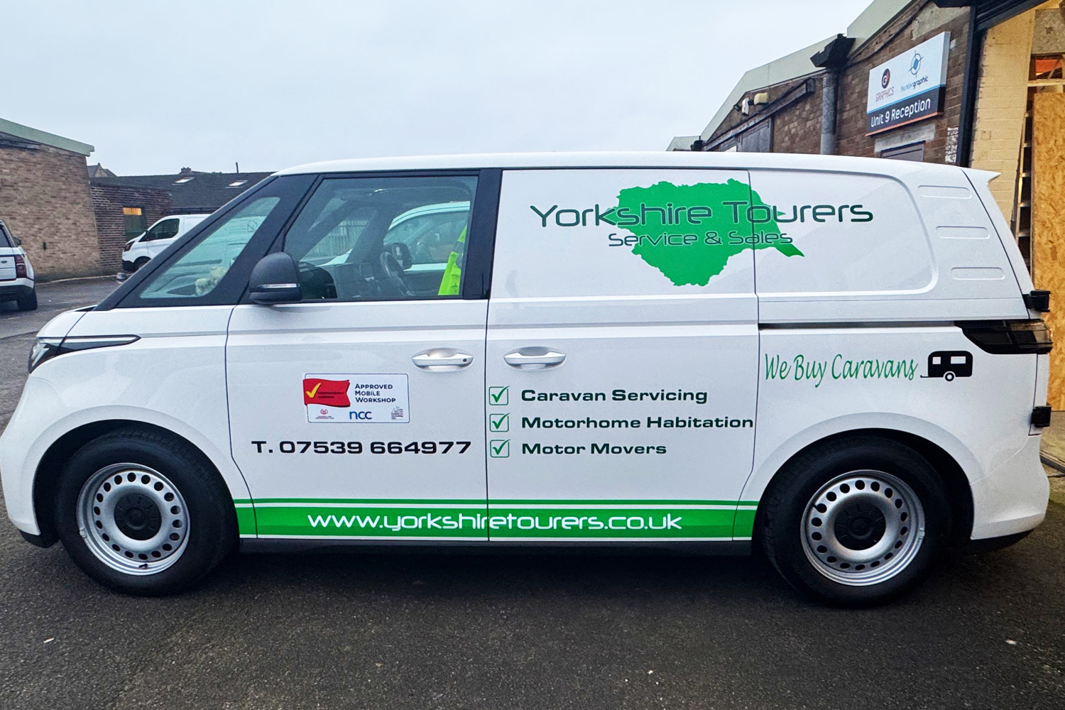 Yorkshire Tourers service and sales van with green map logo, service list, and contact details, offering caravan and motorhome repairs