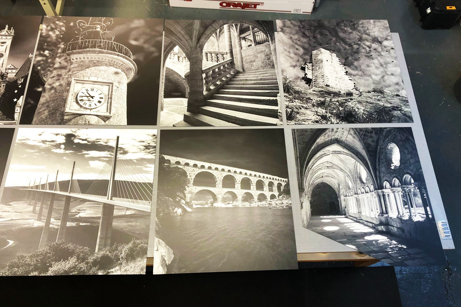 A set of six black and white architectural photographs printed on large wall panels